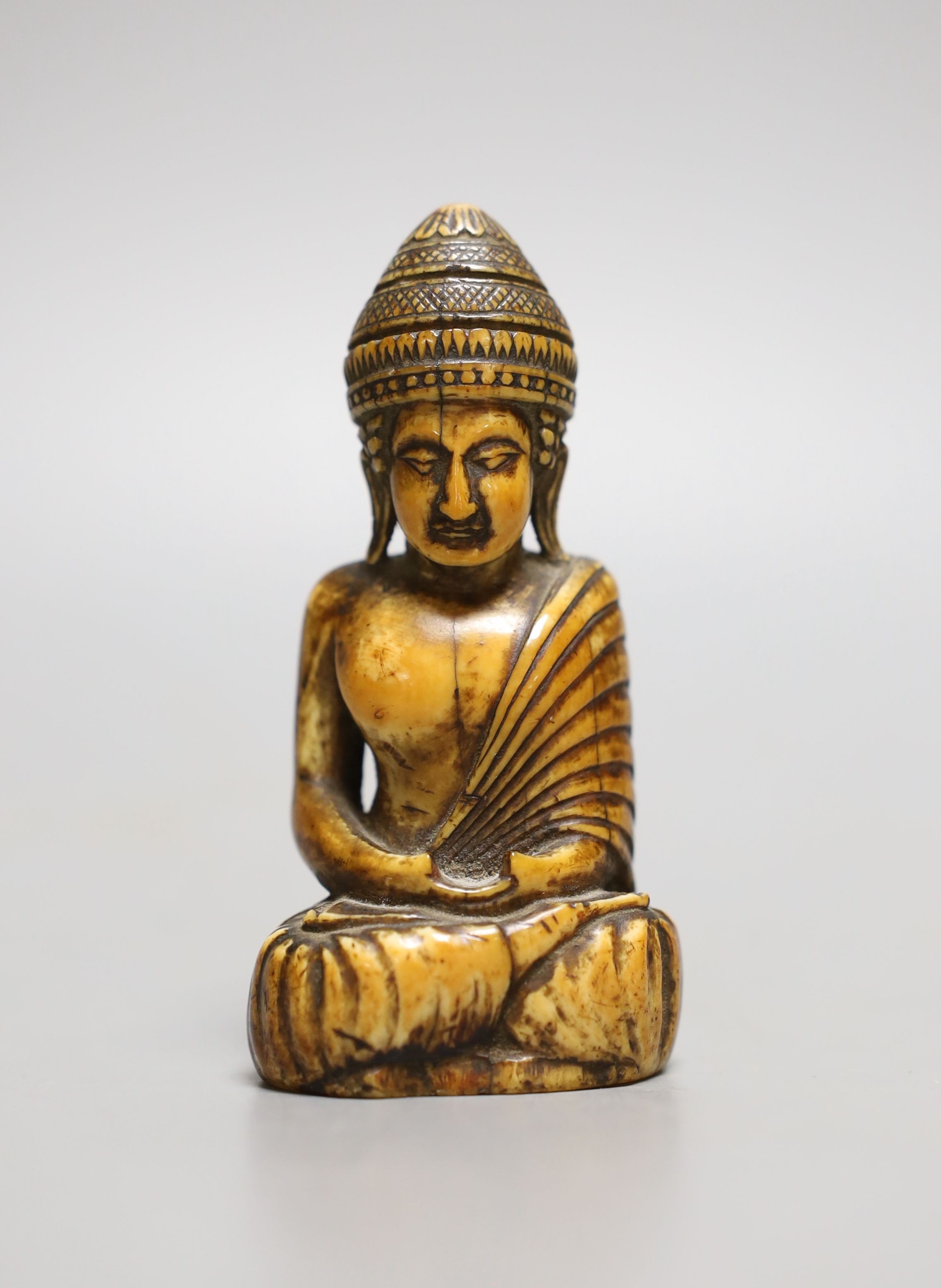 A Thai ivory buddha, probably 8th / 9th century, 9cms high.